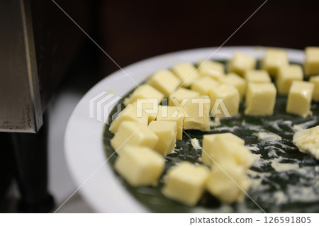 Butter slices are placed on a plate, Cut butter into cubes for baking cake, Whole Pieces of Fresh Butter on The Wooden, Close-up, Macro, and Rotate. Isolated Background of Natural Butter Bars. Butter slices are placed on a plate, Cut butter into cubes for baking cake, Whole Pieces of Fresh Butter on The Wooden, Close-up, Macro, and Rotate. Isolated Background of Natural Butter Bars. 126591805