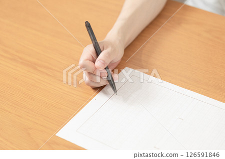 Image of a woman holding manuscript paper and pen (stock photo) 126591846