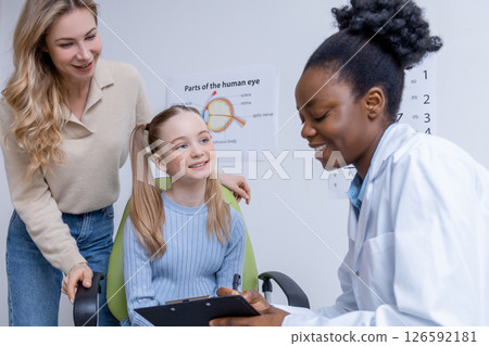 Fair-haired girl and her mom having consultation at the ophthalmologist office Fair-haired girl and her mom having consultation at the ophthalmologist office 126592181