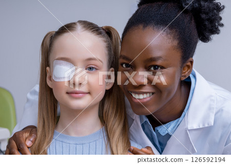 Girl having an exam at the ophthalmologist office and looking positive Girl having an exam at the ophthalmologist office and looking positive 126592194
