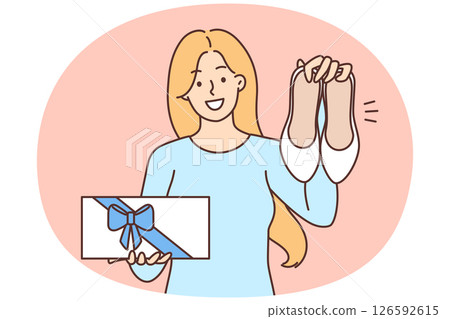 Happy woman showing new shoes and box with gift bow boasting purchase after shopping 126592615