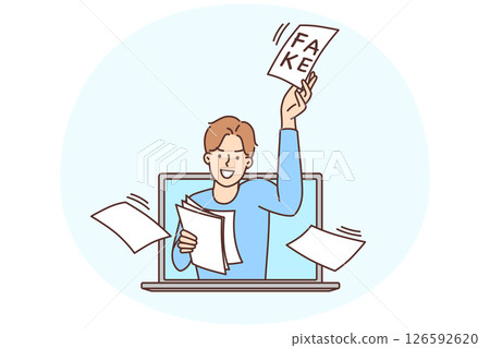 Man looks out of laptop screen scattering pieces of paper with inscription fake 126592620