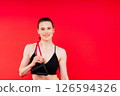Athletic female performs exercises using a resistance band. Strength and motivation 126594326