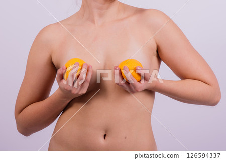 Naked woman back with an orange fruit the isolated image 126594337