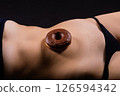 Close up young nice lady woman with slim body perfect skin nude top bra lingerie stand hold donut 126594342
