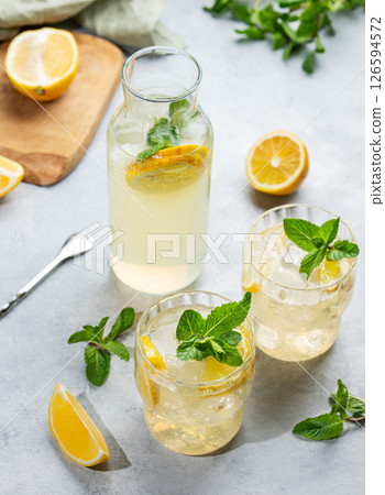 Two glasses of fresh drink lemonade with lemon, mint and ice on a light background 126594572