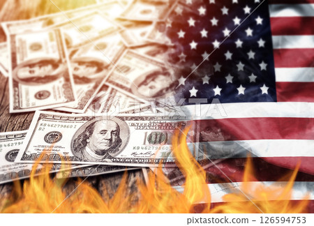 US dollar bank note currency and USA flag burn on fire. the economic crisis in the United States and investors' confidence in the value of the American dollar concept. 126594753
