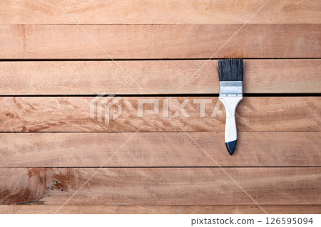 Paint brush and wood material in construction work. 126595094