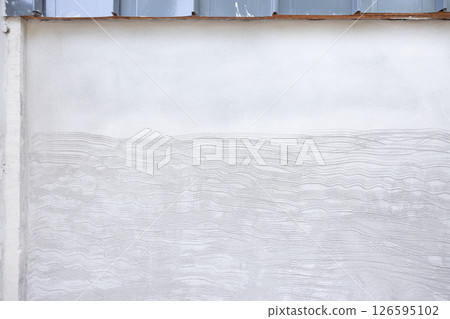 Concrete plastering wall and scrate surface to prepare for tile installation. Concrete plastering wall and scrate surface to prepare for tile installation. 126595102