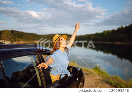 Towards adventure! Young woman is resting and enjoying trip in car. Lifestyle, travel, active life. 126595448