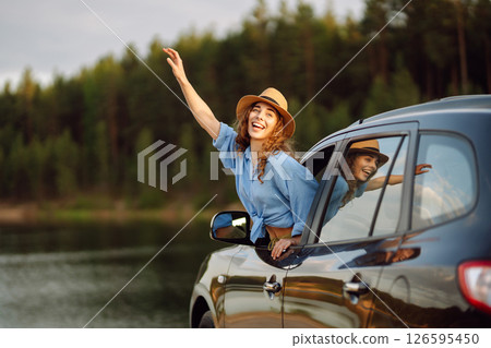 Towards adventure! Young woman is resting and enjoying trip in car. Lifestyle, travel, active life. 126595450