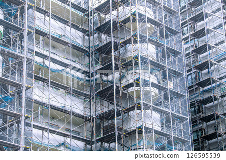 Yokohama cityscape in Japan - Apartment building repairs and inspections, scaffolding and protective netting Yokohama cityscape in Japan - Apartment building repairs and inspections, scaffolding and protective netting 126595539