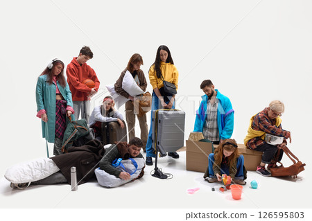 People collapse on floor surrounded by personal belongings after long journey or displacement. Concept of evacuation, refugee experience, social issues 126595803