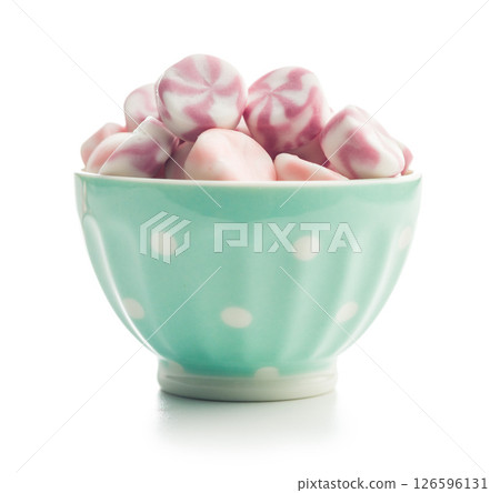 Colorful striped candies in bowl isolated on white background. 126596131