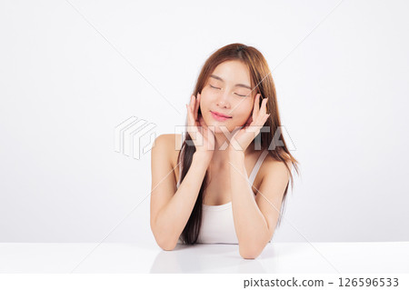 Skin brightness and healthy skin are beautifully displayed as Asian woman gently touches her face, showing elegance, softness, calm satisfaction of complete skincare routine. isolated white background Skin brightness and healthy skin are beautifully displayed as Asian woman gently touches her face, showing elegance, softness, calm satisfaction of complete skincare routine. isolated white background 126596533
