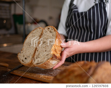 Artisan Sourdough Bread in Hand - Fresh from the Oven. 126597608