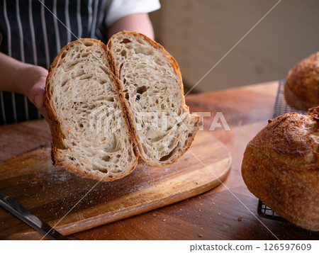 Artisan Sourdough Bread in Hand - Fresh from the Oven. 126597609