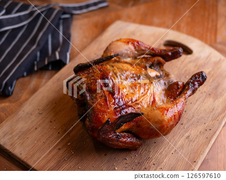 Whole Grilled Chicken on Wooden Table. 126597610