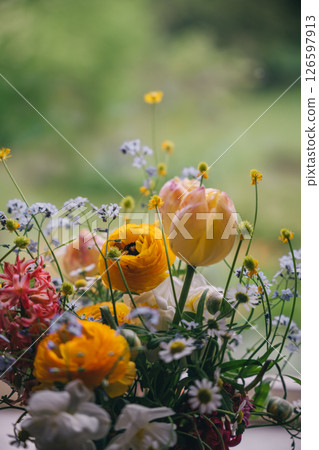 Bright floral arrangement featuring various flowers in a garden setting during springtime Bright floral arrangement featuring various flowers in a garden setting during springtime 126597913
