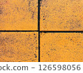 Close-up of yellow concrete tiles with black grout lines 126598056