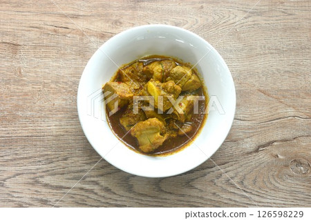 spicy fried pork bone with yellow curry and basil leaf Thai southern food on bowl  126598229
