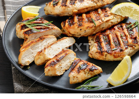 grilled chicken breast with lemon on a plate grilled chicken breast with lemon on a plate 126598664