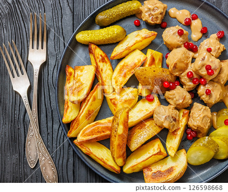 meatballs, potatoes, pickles, berries on a plate 126598668
