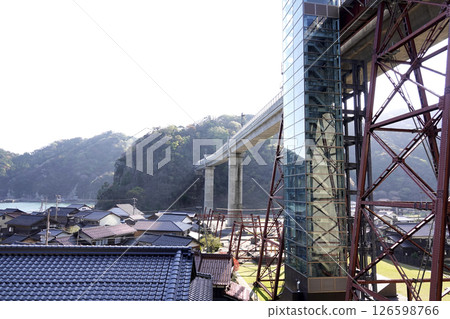 The newly completed concrete Amarube Bridge and the old Amarube Bridge piers, and the elevator tower of Crystal Tower 126598766