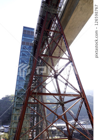 The newly completed concrete Amarube Bridge and the old Amarube Bridge piers, and the elevator tower of Crystal Tower 126598767