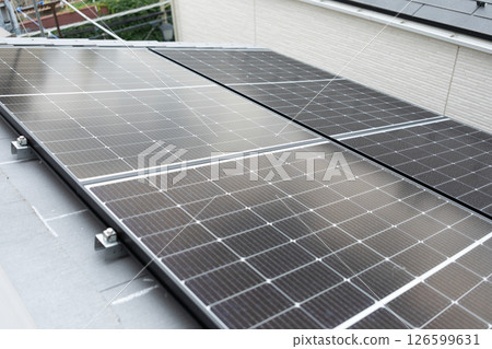Image of solar panels installed on the roof of a house (stock photo) 126599631