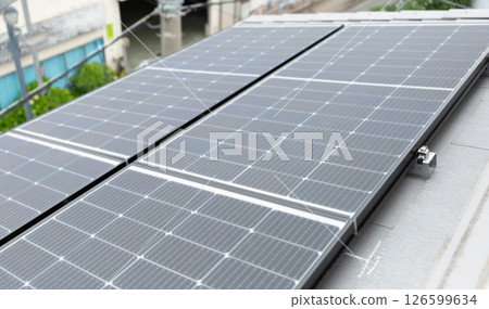 Image of solar panels installed on the roof of a house (stock photo) 126599634