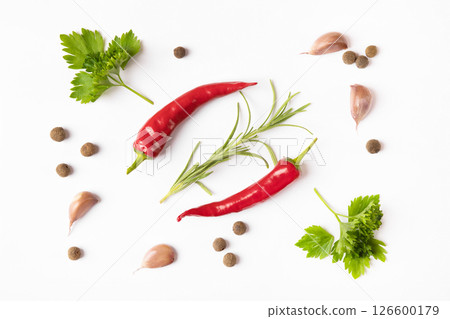 Hot red pepper, spices rosemary sprigs, garlic, parsley and black pepper peas on a gray background. Concept of healthy eating, cooking Hot red pepper, spices rosemary sprigs, garlic, parsley and black pepper peas on a gray background. Concept of healthy eating, cooking 126600179