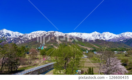 The Hakuba Mountains and the Olympic Ski Jump on a clear day [Hakuba Village, Nagano Prefecture] 126600435