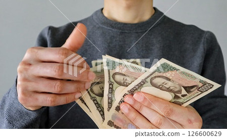 Person counting banknotes 126600629