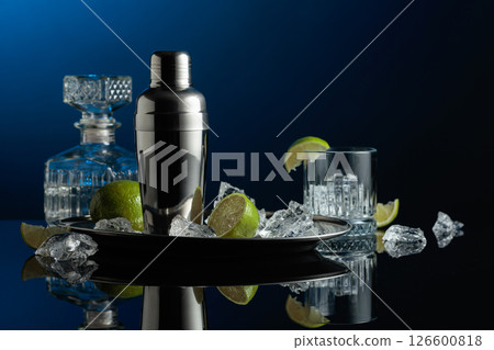 Shaker with crushed ice, lime and vodka. Shaker with crushed ice, lime and vodka. 126600818