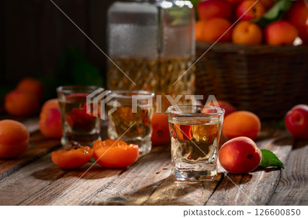 Apricot liqueur or grappa and fresh apricots. Apricot liqueur or grappa and fresh apricots. 126600850