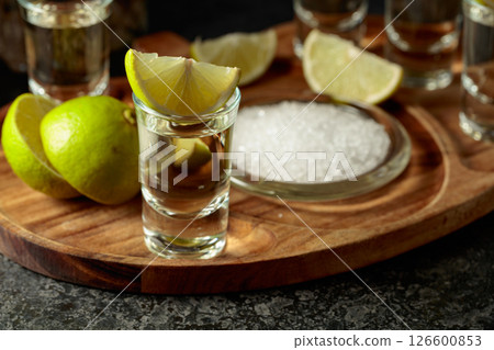 Gold tequila with salt and lime slices. 126600853