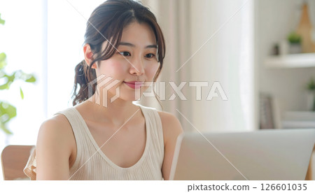 A woman working remotely from home 126601035