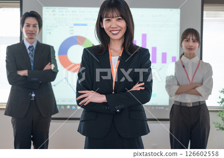 A man and a woman standing in front of a screen in a conference room A man and a woman standing in front of a screen in a conference room 126602558