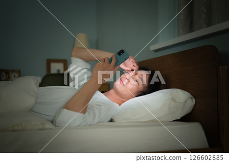 Male smartphone bed 126602885
