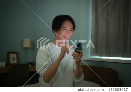 Male smartphone bed 126603087