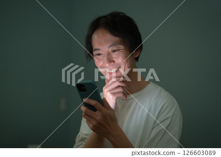 Male smartphone bed 126603089