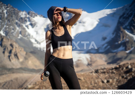 Girl is drinking a water in the mountains. Girl is drinking a water in the mountains. 126603429