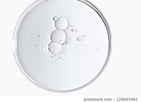 The texture of a cosmetic serum or body gel in a Petri dish. 126603962