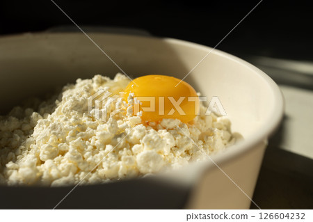 A Fresh Egg Yolk Served Generously on Top of Creamy Cottage Cheese for a Delicious Meal 126604232