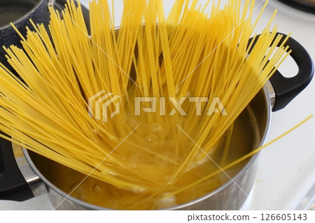 Spaghetti boiling in a saucepan, Italian food 126605143