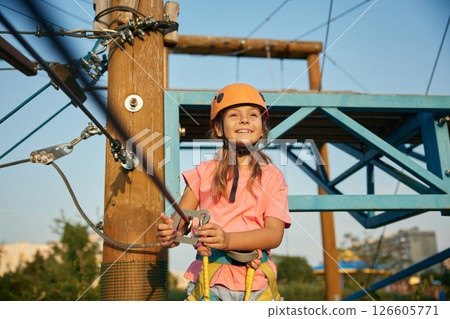 Climber child feeling satisfaction from adventure in rope park Climber child feeling satisfaction from adventure in rope park 126605771
