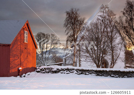 Red house, church and snow in the sunrise, Norway 126605911