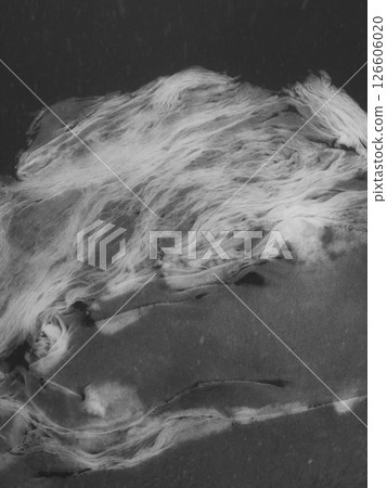 Snowflakes drifting softly over translucent ice surface, generating delicate crystalline patterns perfect for winter themed graphic design and creative visual compositions. Abstract shape and texture 126606020