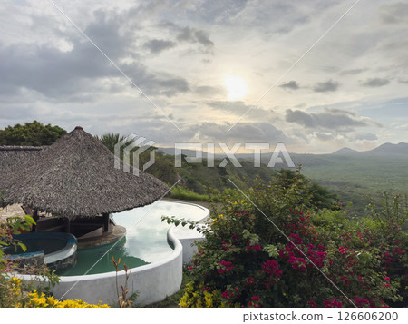 Beautiful hills and serene pool at sunset in tranquil resort setting Beautiful hills and serene pool at sunset in tranquil resort setting 126606200